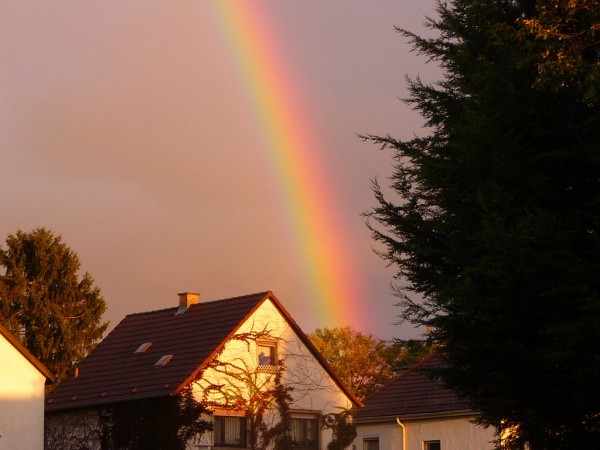 Rainbow Over A House At Sunset